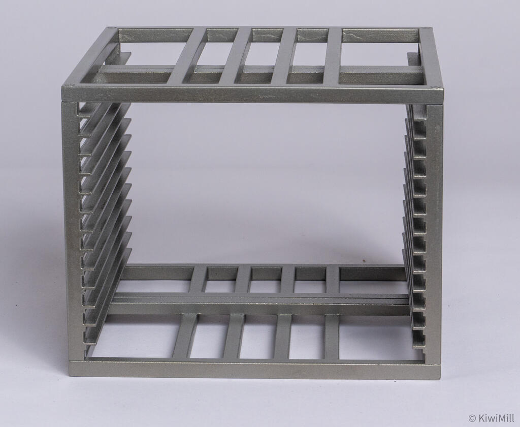 Removed cooking basket from the cook tank model, side view of the bar grid frame with rows of shelf slots